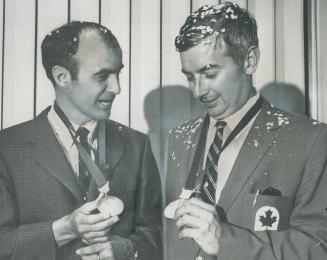 Gold Medals gleaming, Canada's all-conquering equestrians, Jim Elder (left) and Tom Gayrford arrive in Toronto from 1968 Olympic Games in Mexico City.(...)