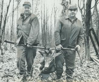 Slogging through woods east of Parry Sound, Hank Rounding, left, of Brampton, and Larry Clelland of Nobel return to camp with one of two deer they sho(...)