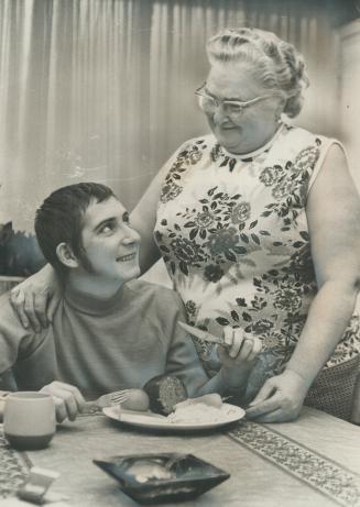 One of the family: Mrs. Katharine Engel looks fondly at jockey Marty Gibson. He calls her Mom, having lost his own mother when he was 14 years of age.(...)