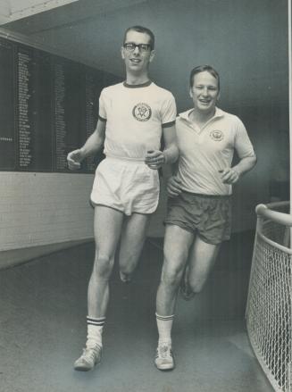 Jogging is beneficial but should be supervised by seasoned jogers say Dr. Robert Goode, right, and Floyd Johnson of the Central YMCA. The two men are shown jogging on the Central YMCA's indoor track