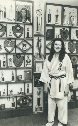 Yvonne LeStrange, 21, displays more than 150 trophies she has won in judo competition