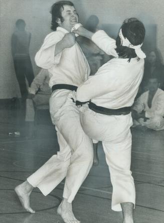 And take that! John Carnio (right) clobbers John Bolta with bandaged right hand to jaw and applies knee at same time during Canadian karate championsh(...)