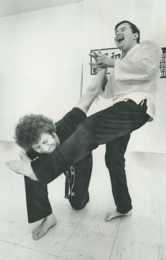 Brian Opekan (right), blind karate student, is enjoying firm grip he has over his helpless teacher, MOnty Guest, in a workout at Kai-Shin Karate Studi(...)