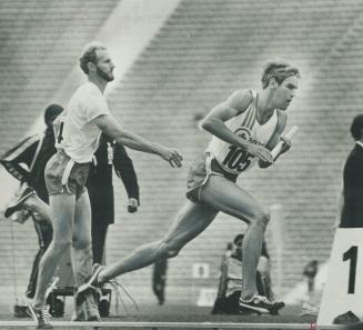 The relays. Practising for the men's 1,600-metre relay, Tony Powell of Canadian team shows down on passing baton to speeding runner Gergen