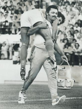 He ain't heavy: K. O. Jack, trainer of the Brazilian Olympic soccer team, doesn't need a stretcher to take injured player Roberto Franqueira from Vars(...)