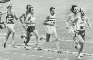 Stepping out: 5,000-metre runner Grant McLaren of Canada passes Germany's Klaus Hildenbrand, who was disqualified briefly for jostling