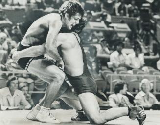 Coming to Grips with it. John Peterson of United States surprised his Olympic freestyle wrestling competition by beating Soviet Viktor Novojilov for t(...)