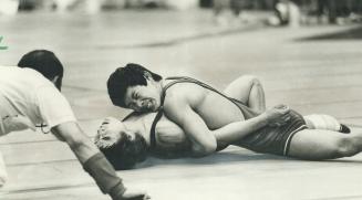 Faces of both men show agonizing strain as Kawasaki puts pin on the Mongolian and referee gets set to verify the hold