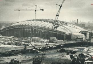 curving Roof of the velodrome being built Montreal for the Olympic Games is near the main stadium, which was planned to have a parachute-style plastic(...)