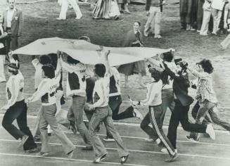 Canadians carry Olympic flag following closing ceremonies