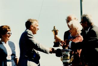 Richard Sanderson receiving trophy' from Jeanne Sauve for queen's plate winner, golden choice