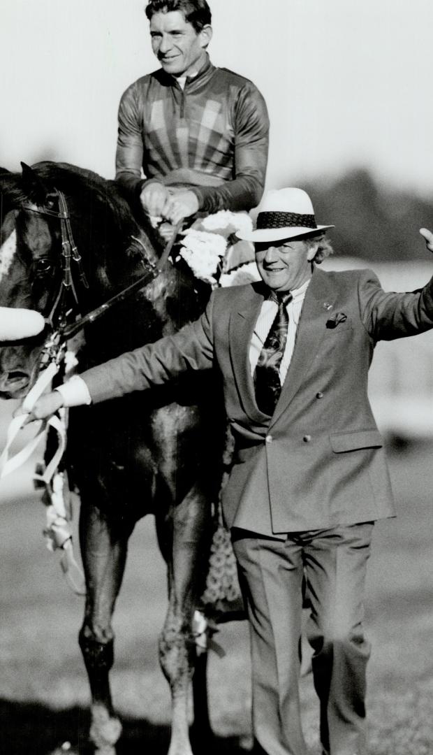 Won in a million: Trainer Roger Attfuekd and jockey Craig Perret show off Molson Export Million winner Peteski yesterday at Woodbine