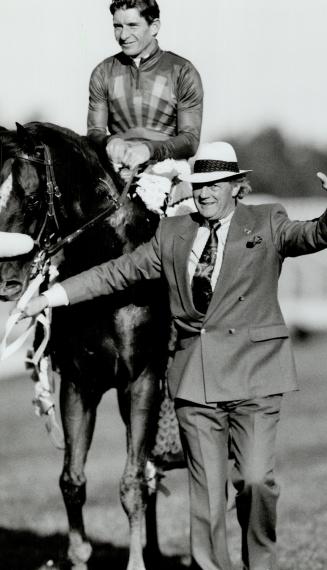 Won in a million: Trainer Roger Attfuekd and jockey Craig Perret show off Molson Export Million winner Peteski yesterday at Woodbine