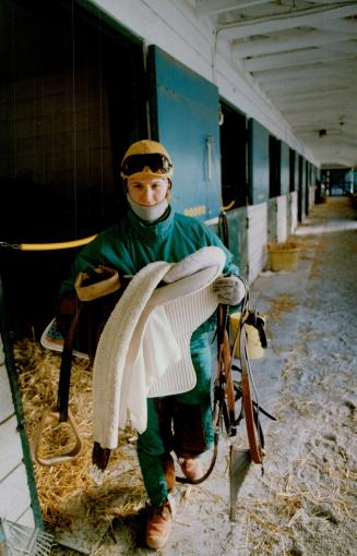 Bundled up against last week's biting cold, exercise lady Gaye Lynch, above, prepares to take a Northern Dancer colt, aptly named Sudden Frost, out for a Woodbine warm-up