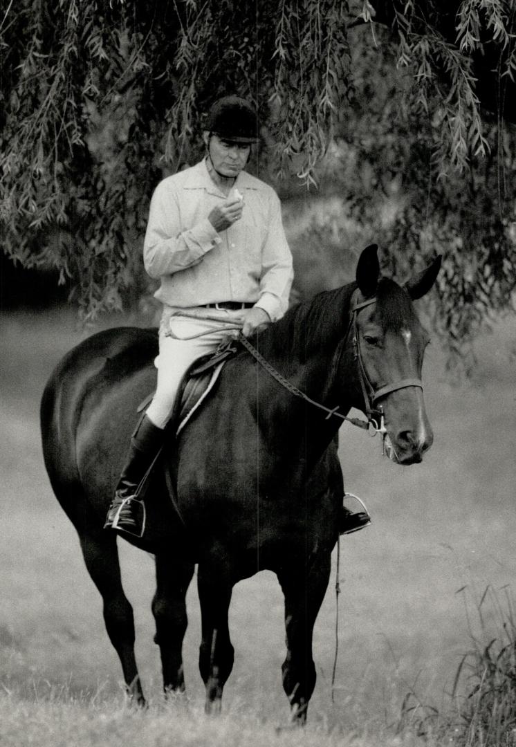 Must eat: Active equestrian and diabetic Jack Murdock, 62, of Uxbridge is shown eating a regularly scheduled meal during a ride on one of his horses