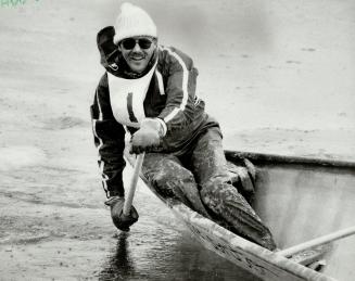 Ron Frenette, captain of the Pier 4 crew, leans out over his canoe