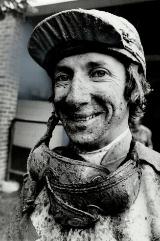 Mud pack: Jockey William McMahon was covered in mud as his mount Ancient Path finished in the pack after six furlongs through the slop in the fifth race at Woodbine yesterday