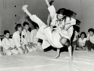 Aii Yahh! Esther Szepesi, 11, decks her judo instructor, George Feher, at the Etobicoke Judo Club yesterday