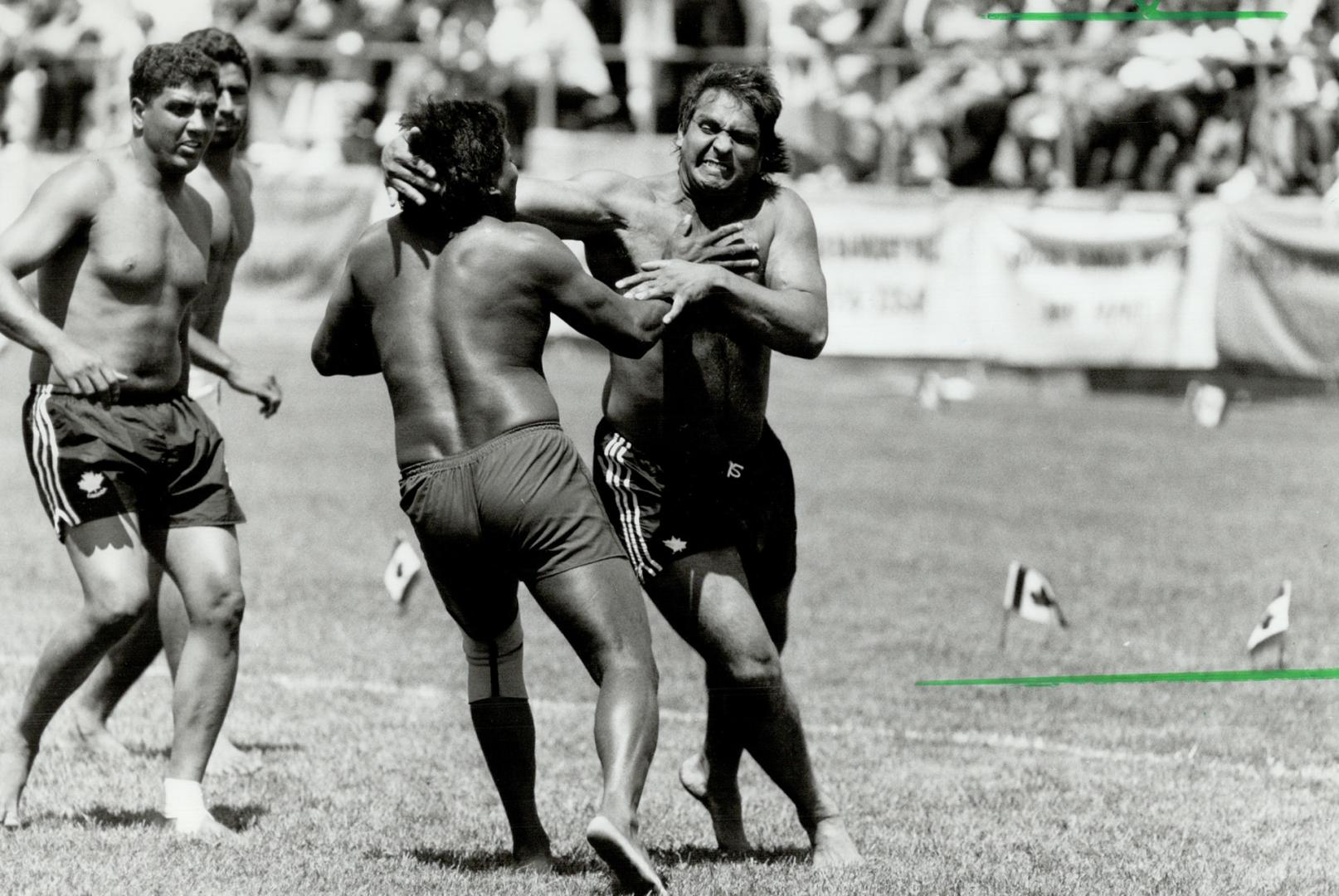 Krazy about kabaddi. Thousands gather at Varsity Stadium for kabaddi tournament yesterday as a member of Scotland's team, below left, battles a member(...)