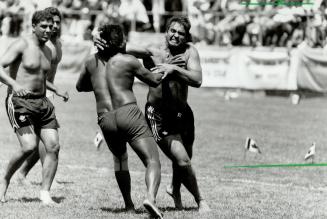 Krazy about kabaddi. Thousands gather at Varsity Stadium for kabaddi tournament yesterday as a member of Scotland's team, below left, battles a member(...)