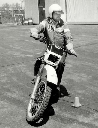 Easy riding: Instructor Ken Elliott takes a motorcycle around a pylon course at Centennial