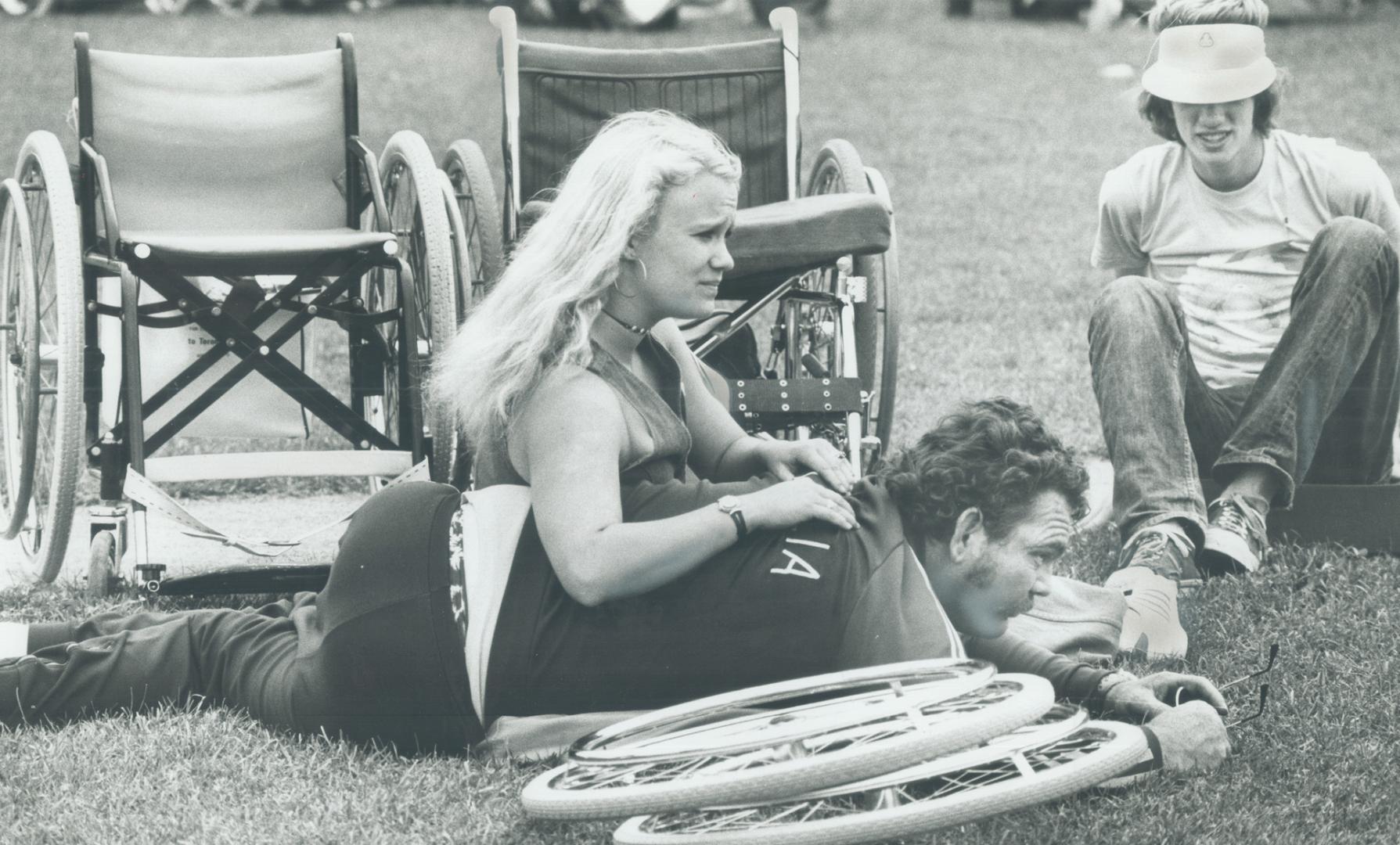 Two members of the Australian team, Gayle Nicholson, left, and Eric Russel, rest as they watch events