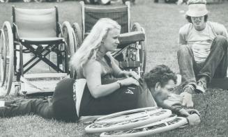 Two members of the Australian team, Gayle Nicholson, left, and Eric Russel, rest as they watch events