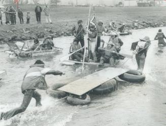 Launching their craft for the 10th annual crazy boat race on the Credit River was an informal affair and somewhat damp for most