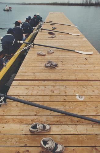 Crew members abandon their footwear on the dock near Cherry Beach before climbing aboard their craft, which comes equipped with permanently anchored shoes