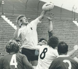 Rick Bailey of the U.S. team climbs over the scrum to grab a loose ball out of the air