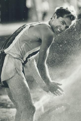Cooling down: Michigan runner Gerard Donarowski finds a quick way to cool off after he took the checkered flag in the 8K Pacesetter event