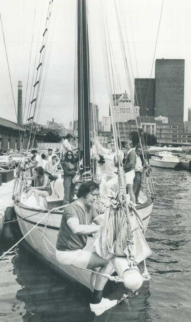 Crew on the schooner wild harp prepare for days sail, Most are novices who have joined the Schooner Club to relax, make friends
