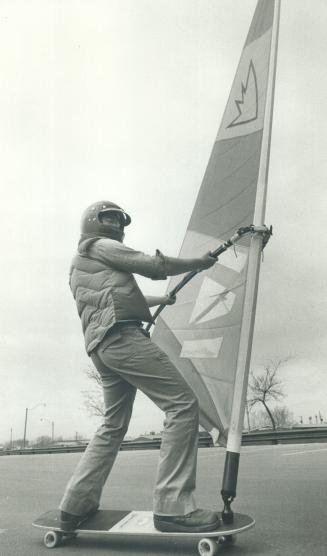 Beached sailor Stan Louden skims over the parking lot at Woodbine Beach on his sailboard, complete with sail, mast and boom on a skateboard base. To b(...)