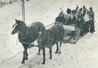 Off on a hay ride on an old-fashioned sleigh, students from Don Mills Junior High School ride through Moccasin Trail Park, just south of Lawrence Ave.(...)