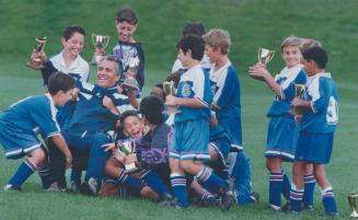Hail to the chief, Peel-Halton boys' under - 10 Hurricane soccer team over whelms coach Frank Lolero after winning the League Cup final with a 1-0 vic(...)