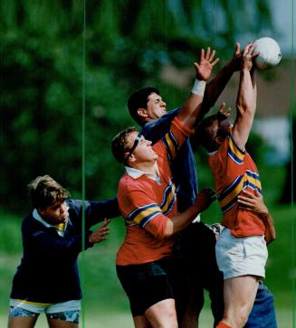 Ball Control: Two members of the Father Bressani Eagles (striped shirts) battle with an Oakridge player during OFSAA rugby action yesterday in Scarborough