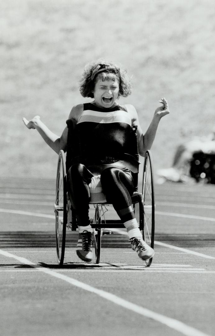 Rolling to a record, Laura Misciagna of Toronto crosses the line to set a national 100-metre record