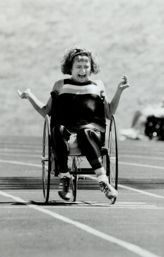 Rolling to a record, Laura Misciagna of Toronto crosses the line to set a national 100-metre record