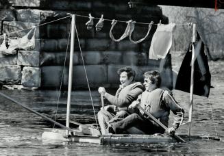 Underwear Over The Water, Lingerie streaming from the clothes line, Phil Day and Jim Kirkland paddle their styrofoam raft down the Credit River Saturd(...)