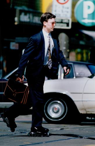 5. Maurice Hefferman, controller at State Street Trust Company, skates to lunch in a Hugo Boss suit, Marek tie. Sunglasses, Ray-Ban, skates, Bauer. Al(...)