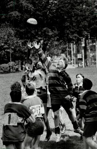 Battle for control: Players from Upper Canada College and Trinity Jostle for position in a bid to land the ball in an under-15 rugby match yesterday