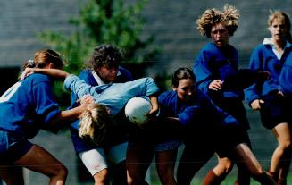 Power struggle, Jessica Horner of Brampton (the one with the ball) gets it from all sides in game between her Toronto Rugby Union West team and Toront(...)