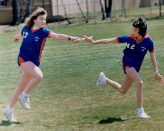 Kerri McLaughlin, left, Passes the baton to Angie Graham, both Grade 7 students at Rosebank public school, during a practice for the Durham track and field finals scheduled for June 8