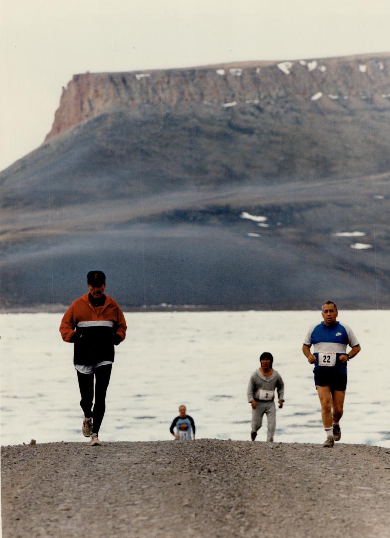 Bleak landscape: Runners in the Midnight Sun Marathon on Baffin Island must cover a gruelling 26-mile gravel course that rises 3,000 feet from start to finish