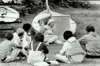 Left, Judy Lugar, 21, of Halifax, huddles her students for some words of advice before the group takes to the water at the Ontario Sailing Centre near(...)