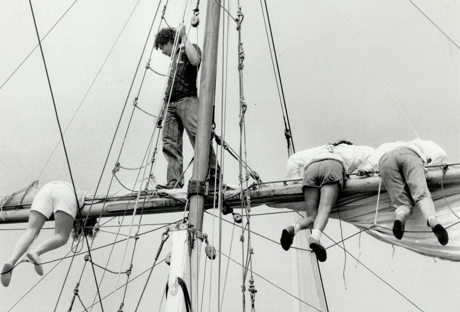 Ahoy, mates! Would-be participants in Operation Raleigh settle in on the yardarm of the square-rigged ship used for training yesterday in Toronto Harb(...)