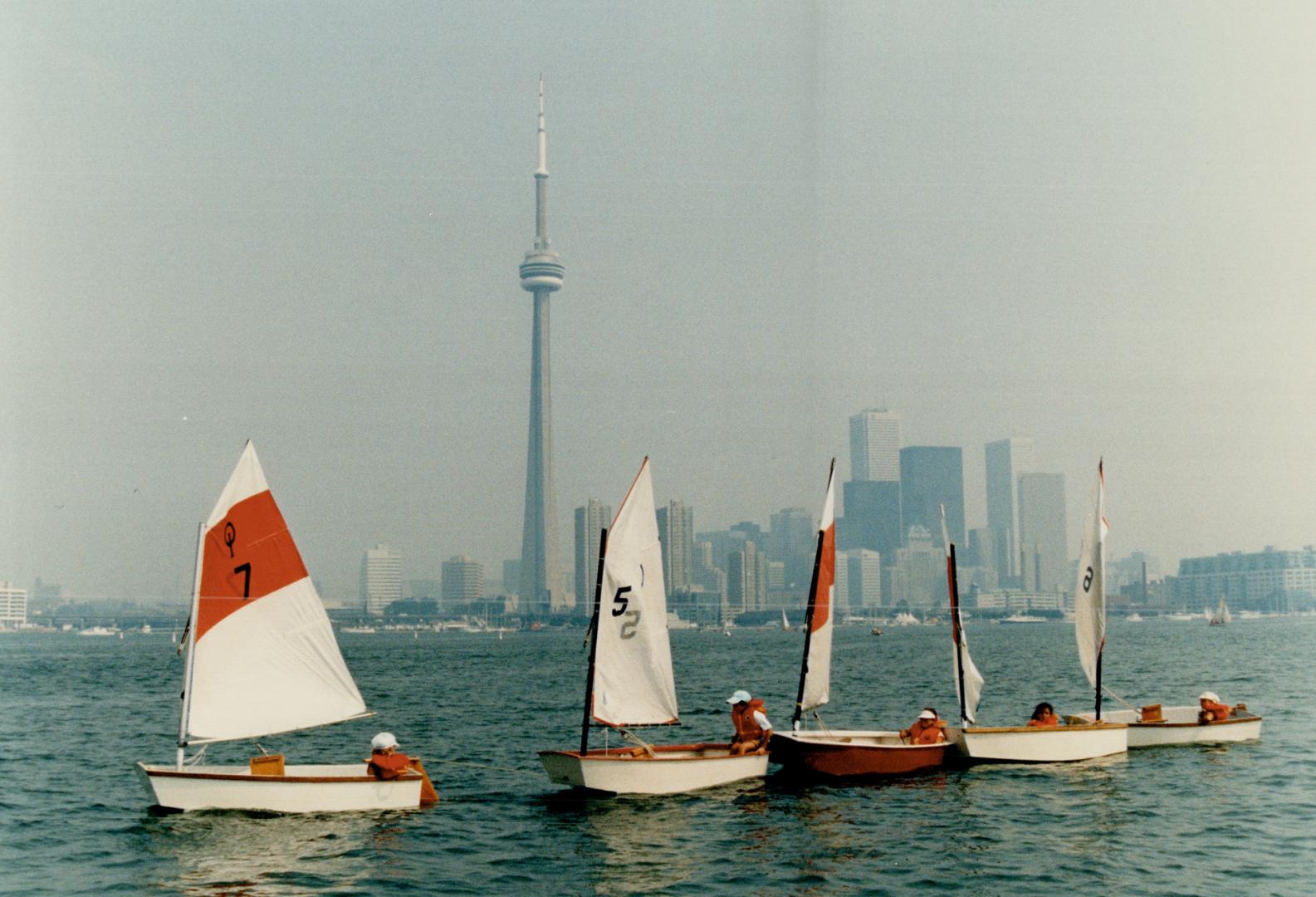 Right, children participating in the Island Yacht Club's four-week sailing school play follow the leader in Toronto harbor