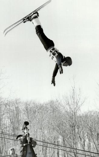 Going up in the world, Paul Henry, a Canadian freestyle skier, goes hurtling through the air in the aerial event at the Challenge '82 competition on t(...)