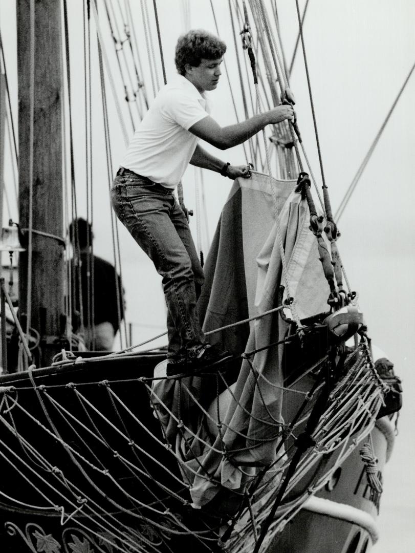 All set to cast off, Crewman Torfi Thorarinson sets bow lines on the 60-foot brigantine Playfair in Toronto Harbor as the vessel's non-profit sailing program starts a new season