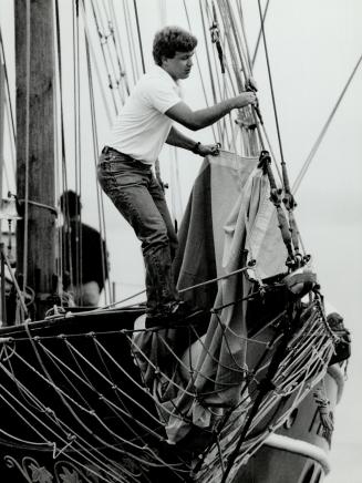 All set to cast off, Crewman Torfi Thorarinson sets bow lines on the 60-foot brigantine Playfair in Toronto Harbor as the vessel's non-profit sailing program starts a new season
